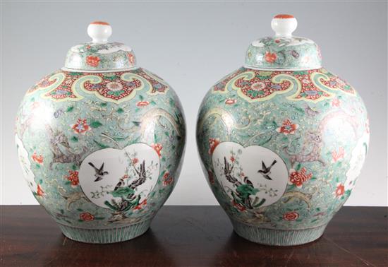 A pair of Chinese famille verte ovoid jars and covers, late 19th century, 31cm, one cover repaired